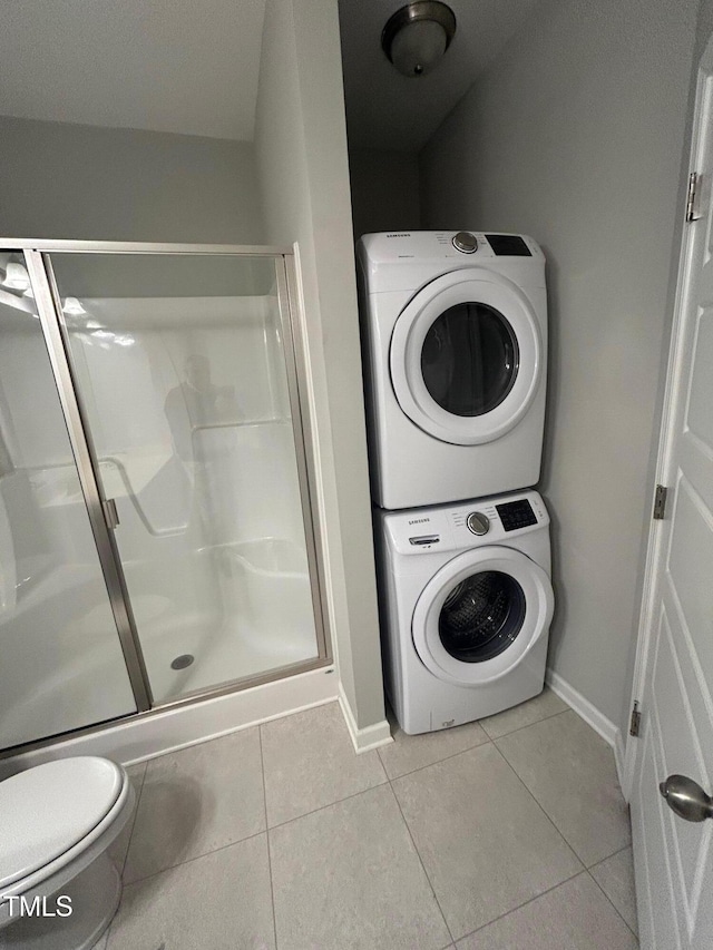 48 Cullen Ct, Clayton, NC 27520 - clothes washing area with stacked washing maching and dryer, laundry area, baseboards, and tile patterned floors