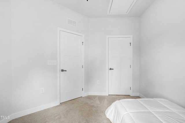 bedroom with attic access, baseboards, visible vents, and carpet flooring