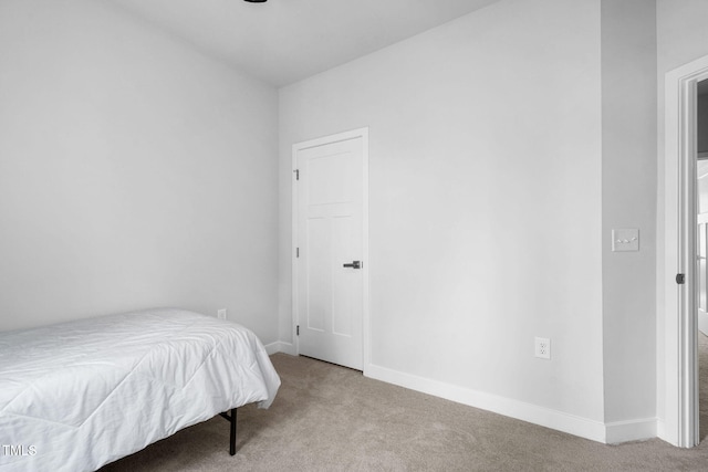 carpeted bedroom featuring baseboards