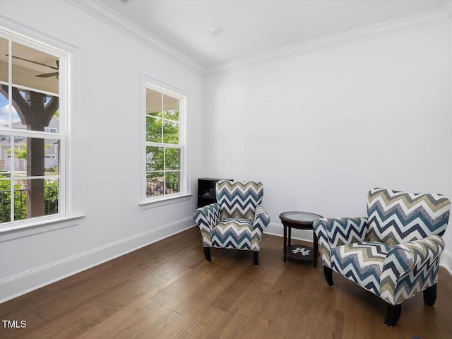 sitting room with wood finished floors, baseboards, and ornamental molding