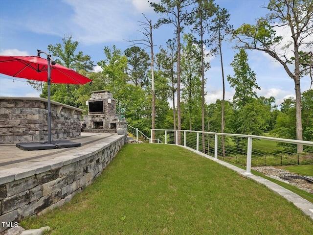 view of yard with an outdoor stone fireplace