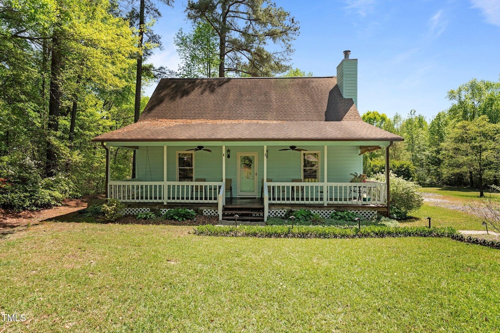 209 Pen Lou Ct, Angier, NC 27501 - farmhouse inspired home featuring a ceiling fan, a porch, a front yard, a chimney, and a shingled roof