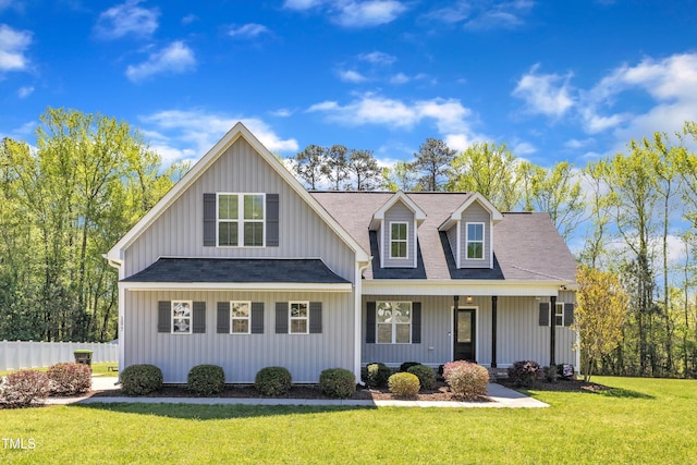 1077 Williams-White Rd, Zebulon, NC 27597 - view of front facade featuring roof with shingles, fence, a front lawn, and covered porch