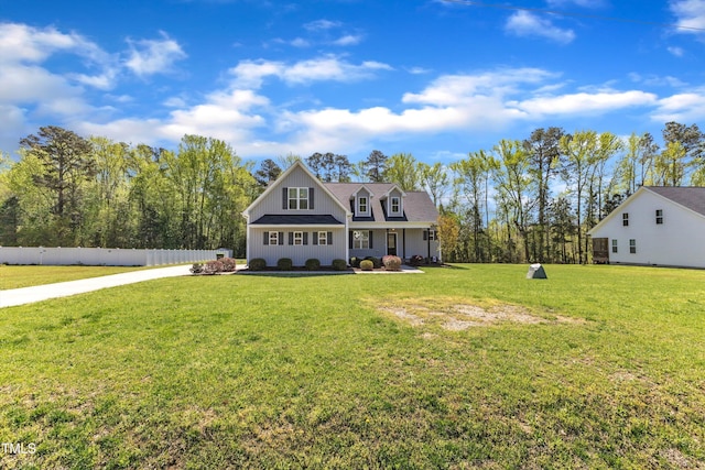 1077 Williams-White Rd, Zebulon, NC 27597 - view of front of home with board and batten siding, fence, and a front lawn