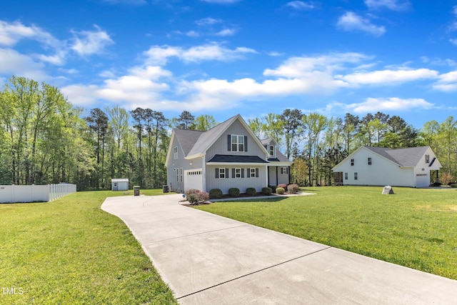 1077 Williams-White Rd, Zebulon, NC 27597 - view of front of home with driveway, board and batten siding, a garage, fence, and a shingled roof