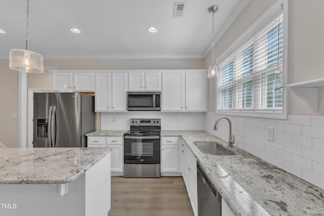 1077 Williams-White Rd, Zebulon, NC 27597 - kitchen featuring white cabinetry, a sink, crown molding, and appliances with stainless steel finishes