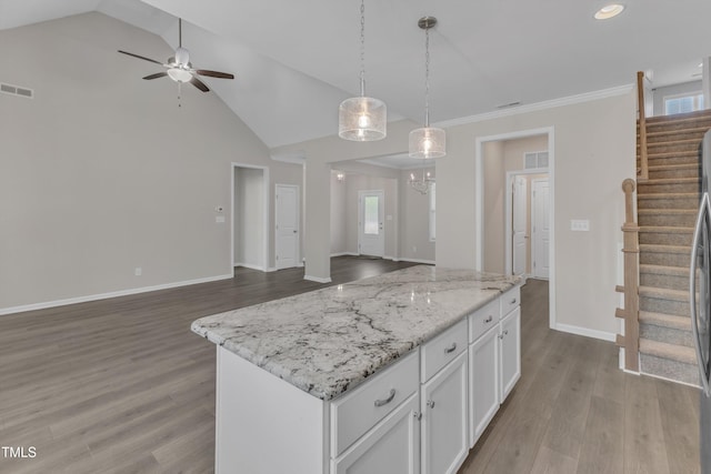 1077 Williams-White Rd, Zebulon, NC 27597 - kitchen with open floor plan, wood finished floors, visible vents, and white cabinets