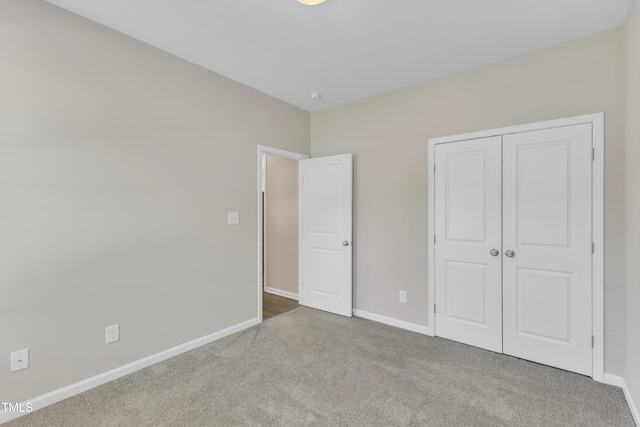 1077 Williams-White Rd, Zebulon, NC 27597 - unfurnished bedroom featuring a closet, baseboards, and carpet