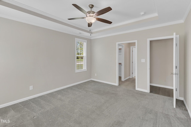 1077 Williams-White Rd, Zebulon, NC 27597 - unfurnished bedroom featuring crown molding, a spacious closet, carpet flooring, a raised ceiling, and baseboards