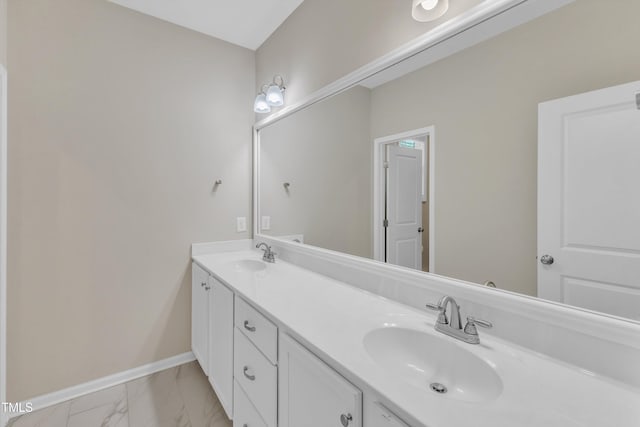 1077 Williams-White Rd, Zebulon, NC 27597 - bathroom featuring double vanity, marble finish floor, a sink, and baseboards