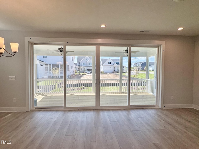 doorway to outside with baseboards, a ceiling fan, and wood finished floors