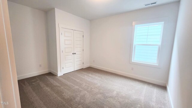 1237 Porters Call Dr, Wendell, NC 27591 - unfurnished bedroom featuring carpet flooring and a closet