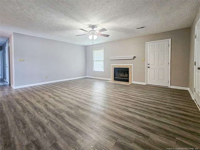 unfurnished living room with a fireplace, dark wood-type flooring, baseboards, and a ceiling fan