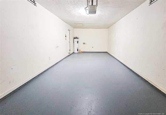 garage featuring electric water heater and a garage door opener