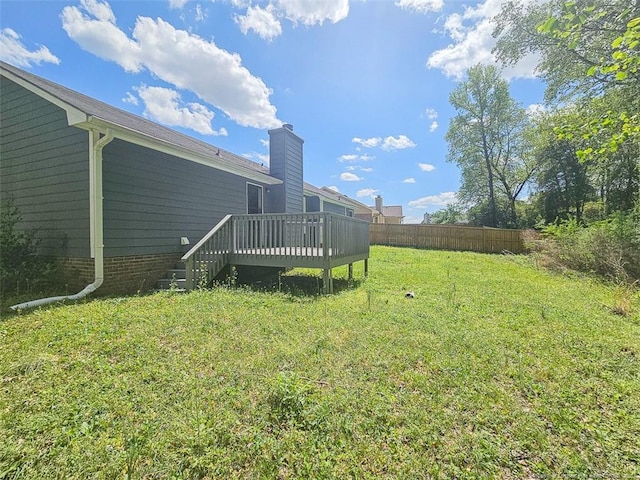 view of yard featuring fence and a deck