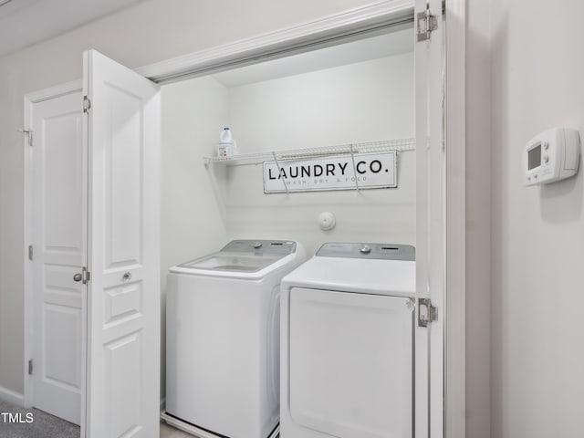 laundry area with laundry area and washer and clothes dryer