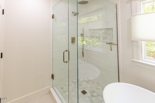 full bathroom with a shower stall and tile patterned floors