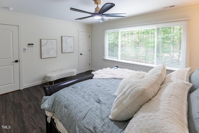 bedroom with wood finished floors, baseboards, crown molding, and ceiling fan