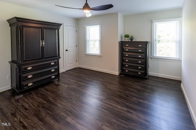 bedroom with baseboards, dark wood finished floors, and a ceiling fan