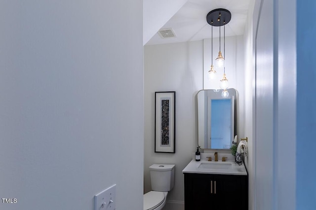 half bath featuring toilet and vanity