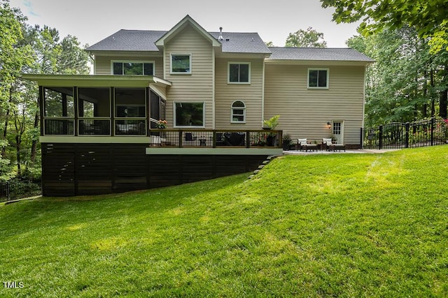 back of house with a sunroom, a deck, and a patio area