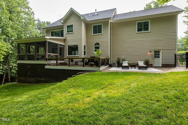 rear view of property with a patio area, a sunroom, and a yard