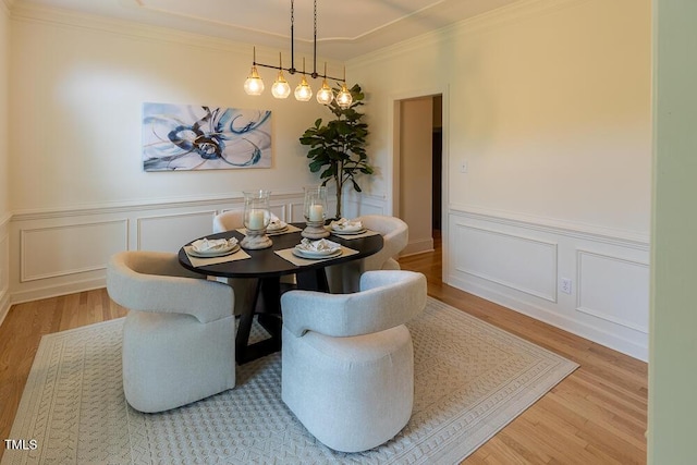 5025 Martin Farm Rd, Raleigh, NC 27613 - dining room with wood finished floors, a wainscoted wall, a decorative wall, and crown molding