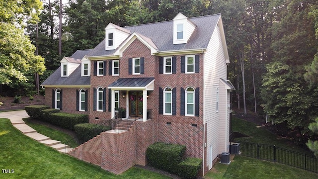 5025 Martin Farm Rd, Raleigh, NC 27613 - view of front of property with brick siding, central air condition unit, and view of scattered trees