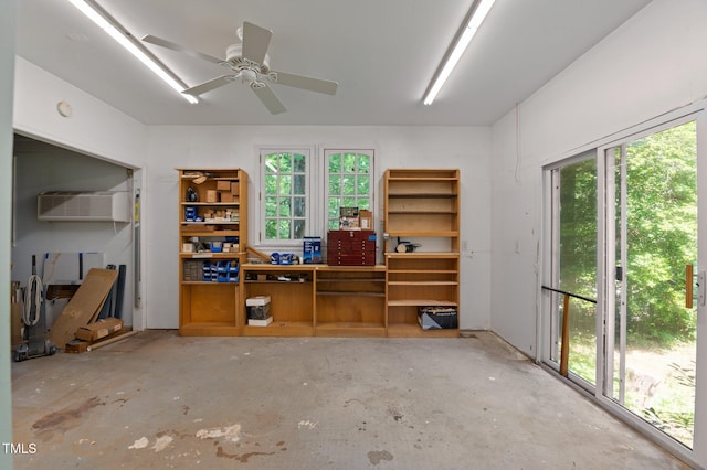 373 Sagamore Dr, Louisburg, NC 27549 - office area with an AC wall unit, a workshop area, and unfinished concrete flooring