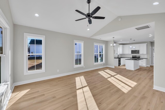 617 Ray St, Selma, NC 27576 - unfurnished living room with visible vents, light wood-type flooring, a ceiling fan, and lofted ceiling