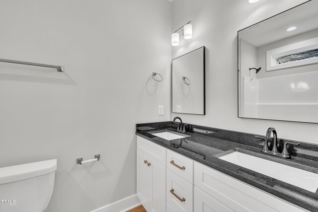 617 Ray St, Selma, NC 27576 - full bath featuring double vanity, baseboards, a sink, and toilet
