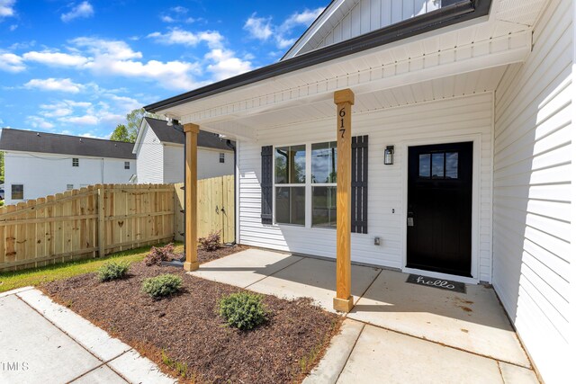 617 Ray St, Selma, NC 27576 - doorway to property featuring board and batten siding and fence