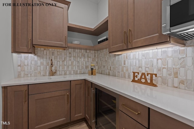kitchen with tasteful backsplash, open shelves, a sink, wine cooler, and stainless steel microwave