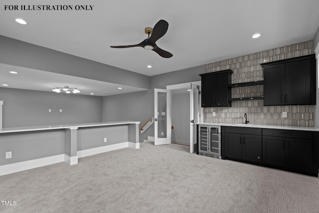 bar featuring light colored carpet, a ceiling fan, a sink, wine cooler, and backsplash