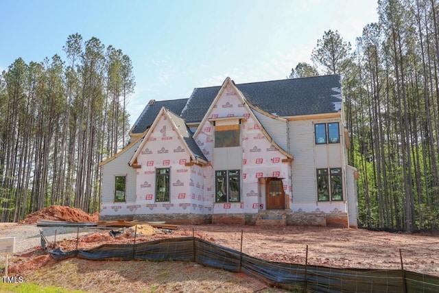 property under construction with a shingled roof