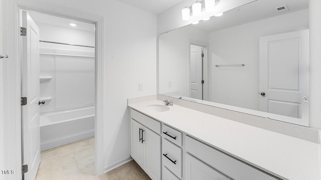 bathroom featuring vanity, baseboards, and tile patterned floors