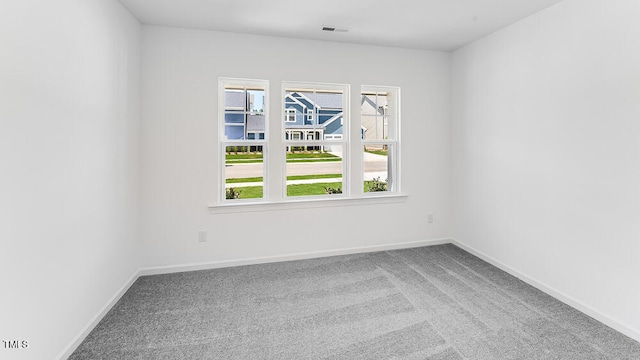 carpeted empty room with baseboards