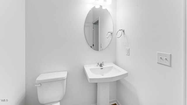 bathroom featuring toilet and a sink