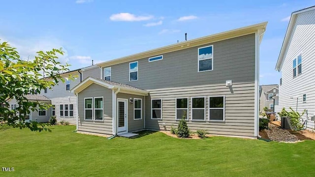 rear view of property with a yard
