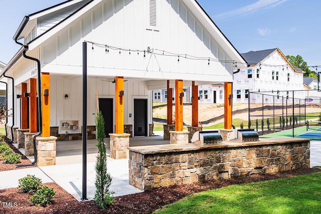 view of front facade featuring board and batten siding and fence