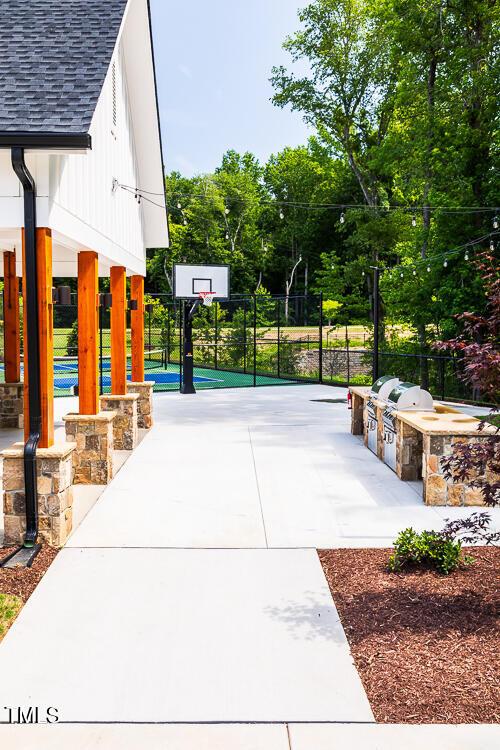 view of sport court featuring fence and community basketball court