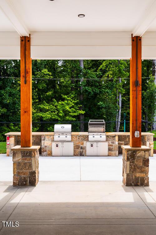 view of patio / terrace with exterior kitchen and a grill