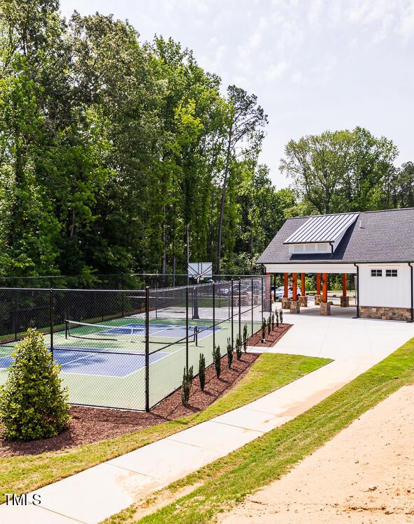 view of tennis court featuring fence