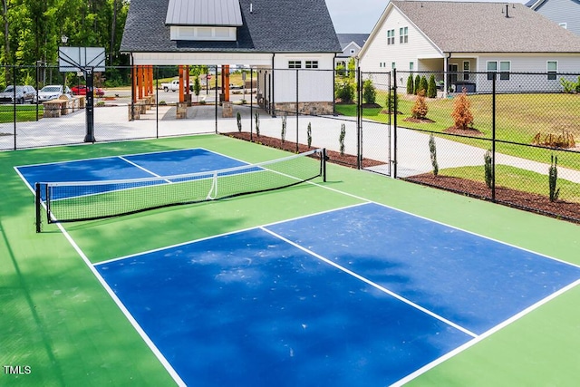 view of tennis court with fence and community basketball court