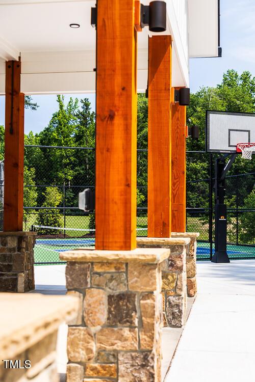 view of patio / terrace featuring community basketball court and fence