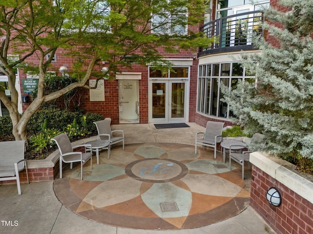 view of patio / terrace featuring a balcony and french doors