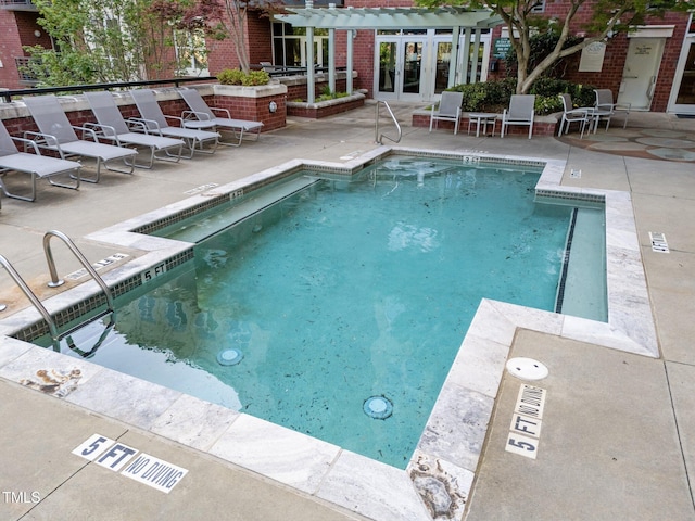 community pool featuring french doors, a pergola, and a patio area