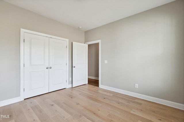 9220 Yardley Town Dr, Wake Forest, NC 27587 - unfurnished bedroom with baseboards, a closet, and light wood-type flooring