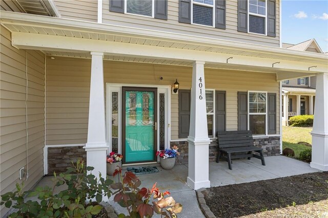 4016 Baywood Point Dr, Fayetteville, NC 28312 - view of exterior entry featuring covered porch and stone siding