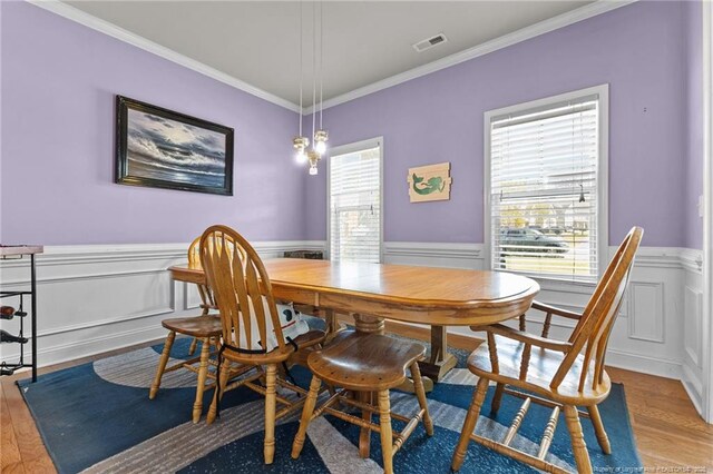 4016 Baywood Point Dr, Fayetteville, NC 28312 - dining area featuring wood finished floors, visible vents, and a wainscoted wall